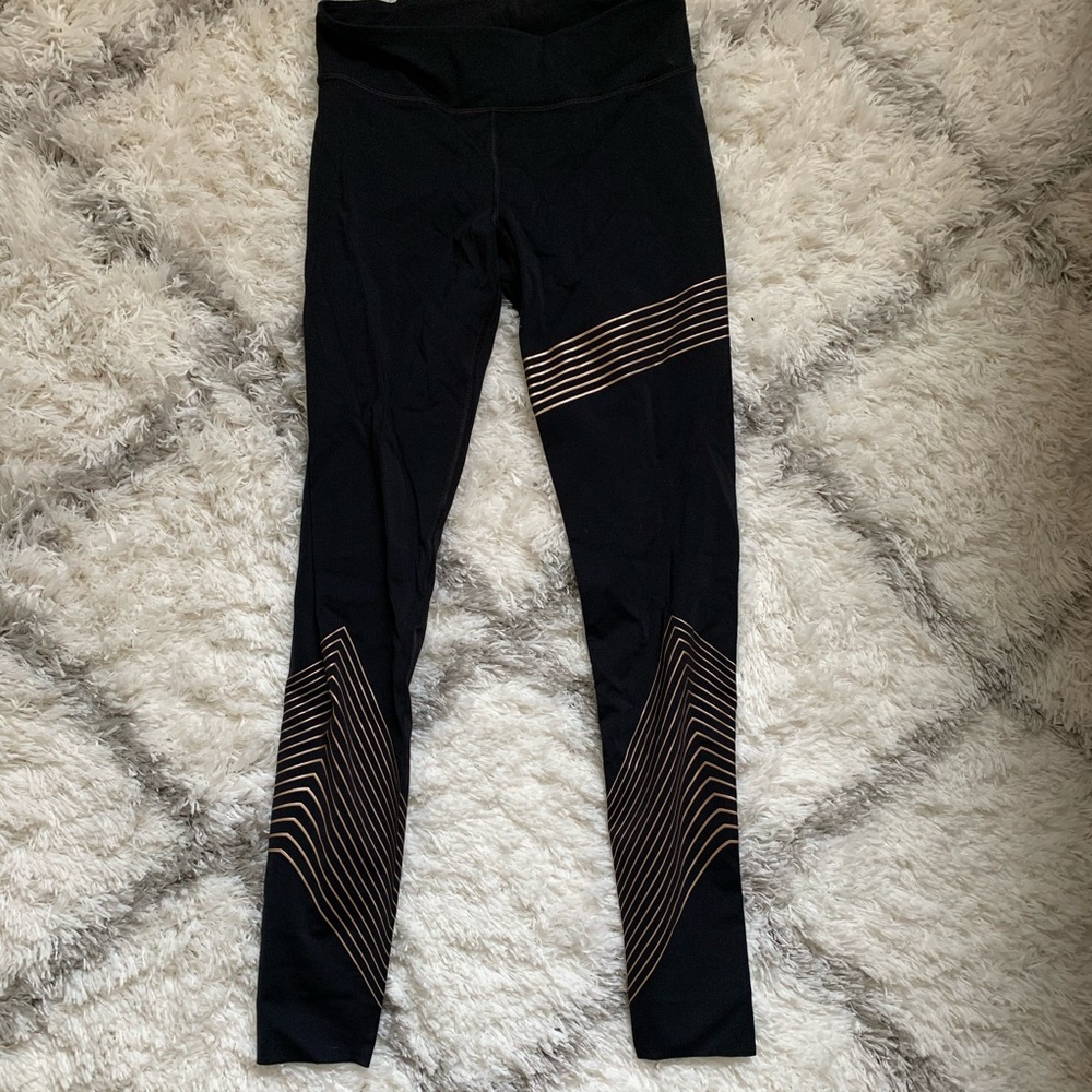 UA gold stripe tights